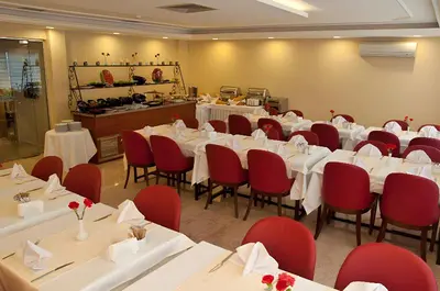 a conference room with white tables and red chairs at Abel Hotel in Istanbul