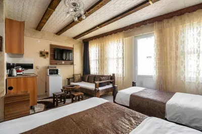 a hotel room with two beds and a couch at Pi Home & Apartments in Istanbul