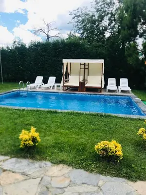 a swimming pool with chairs and a table and a table and chairs at The Doctor's House in Sapanca