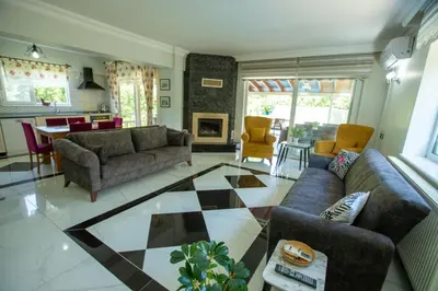 a living room with couches and a checkerboard floor at The Doctor's House in Sapanca