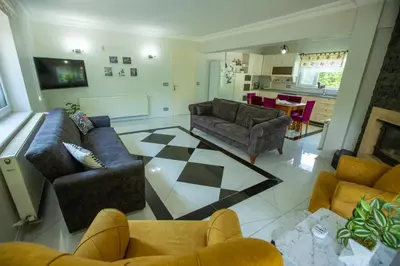 a living room with two couches and a kitchen at The Doctor's House in Sapanca