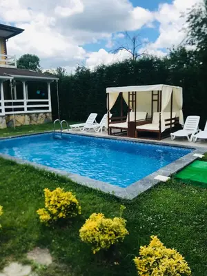 a swimming pool with chairs and a gazebo at The Doctor's House in Sapanca