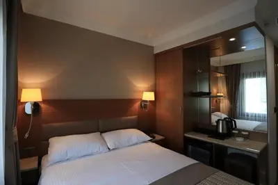 a hotel room with a bed and a sink at NL Amsterdam Hotel in Istanbul