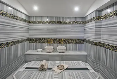 a sauna with a tub and two sinks in it at Cevahir Hotel Istanbul Asia in Istanbul