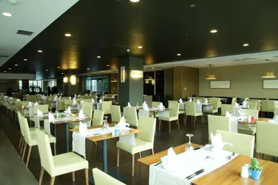 a dining room with tables and white chairs at Cevahir Hotel Istanbul Asia in Istanbul