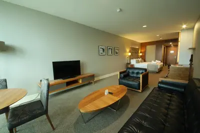 a living room with a couch and a tv at Cevahir Hotel Istanbul Asia in Istanbul