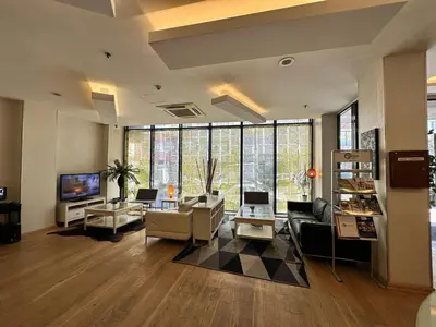 a living room with furniture and a large window at Tempo Hotel 4Levent in Istanbul