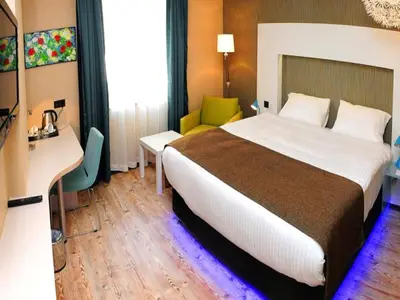 a hotel room with a large bed and a desk at Tempo Hotel 4Levent in Istanbul