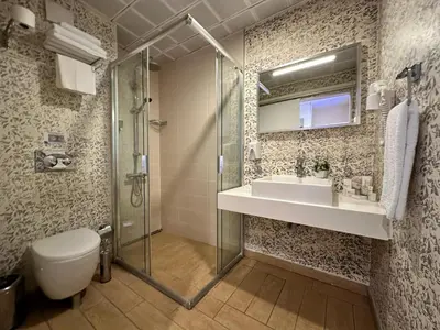 a bathroom with a shower and a sink and a toilet at Tempo Hotel 4Levent in Istanbul