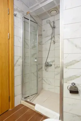 a shower with a glass door in a bathroom at P Galata Hotel - Special Category in Istanbul