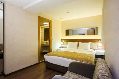 a hotel room with a bed and a couch at P Galata Hotel - Special Category in Istanbul