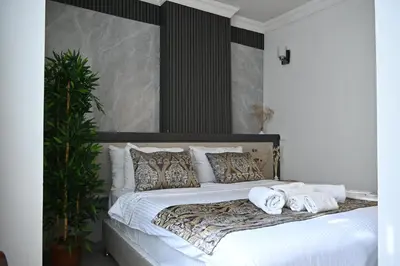 a large white bed with pillows and towels on it at Elite Marmara Hotel Gungoren in Istanbul