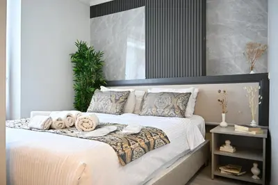a bedroom with a large bed with towels on it at Elite Marmara Hotel Gungoren in Istanbul