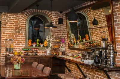 a brick walled kitchen with a table and chairs at Meroddi Galata Mansion in Istanbul