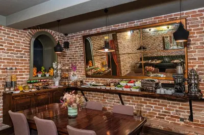 a dining room with a brick wall and a table at Meroddi Galata Mansion in Istanbul
