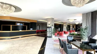 a lobby of a hotel with chairs and a bar at Ramada by Wyndham Tekirdağ in Tekirdag
