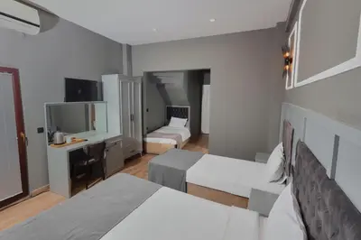 a hotel room with two beds and a desk at Ortakoy Aysem Sultan Hotel in Istanbul