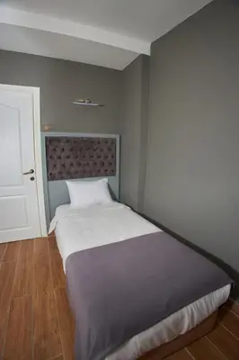 a bedroom with a large bed with white sheets at Ortakoy Aysem Sultan Hotel in Istanbul