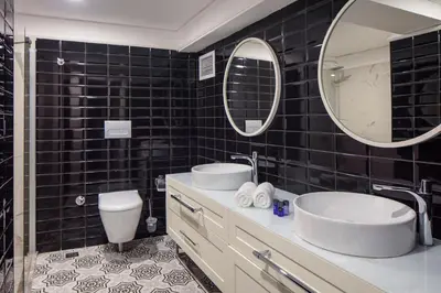 a bathroom with a sink and a toilet and a mirror at B LOFT HOTEL in Bursa
