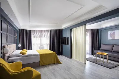 a bedroom with a king sized bed and a couch at B LOFT HOTEL in Bursa