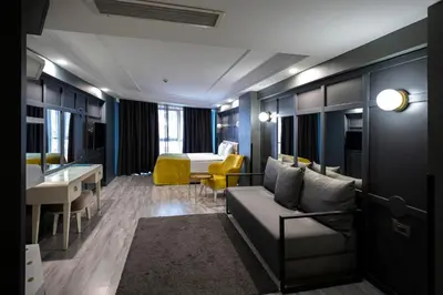 a hotel room with a couch and a table and a bed at B LOFT HOTEL in Bursa