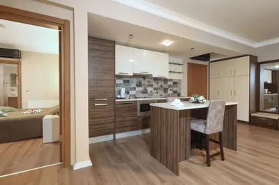 a kitchen and living room with a bed and a table at Balturk House Hotel in Kocaeli