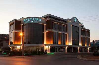 a building with a sign for a house hotel at Balturk House Hotel in Kocaeli