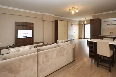 a living room with a large couch and a table at Balturk House Hotel in Kocaeli