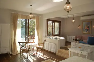 a living room with a sink and a table and chairs at Beyaz Ev Agva - Adult only +15 in Agva