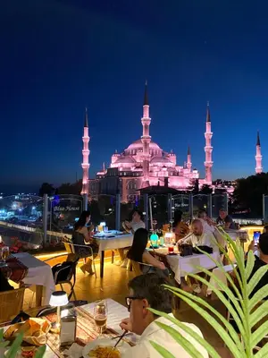 a group of people sitting at tables on the roof of a building at Blue House Hotel Old City - Sultanahmet in Istanbul