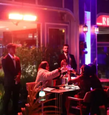 a group of people sitting around a table in a restaurant at Blue House Hotel Old City - Sultanahmet in Istanbul