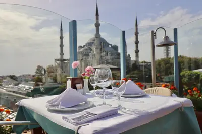a table with two wine glasses and a view of a city at Blue House Hotel Old City - Sultanahmet in Istanbul