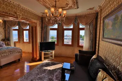 a living room with a bed and a television at Blue House Hotel Old City - Sultanahmet in Istanbul