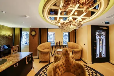 a living room with a chandelier and a table and chairs at Katelya Hotel in Istanbul