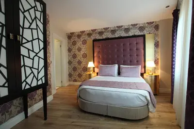 a bedroom with a large bed with a large headboard at Katelya Hotel in Istanbul