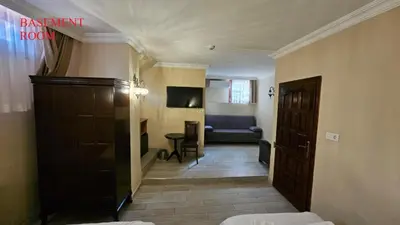 a hallway of a hotel room with a door and a couch at Ottoman Elegance Hotel in Istanbul