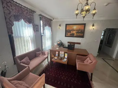a living room with a couch and a table and chairs at Ottoman Elegance Hotel in Istanbul