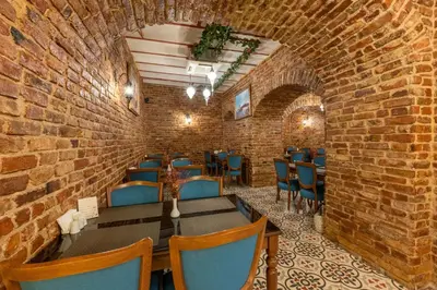 a restaurant with a brick wall and tables and chairs at Meserret Palace Hotel - Special Category in Istanbul