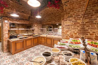a large kitchen with many plates of food on display at Meserret Palace Hotel - Special Category in Istanbul