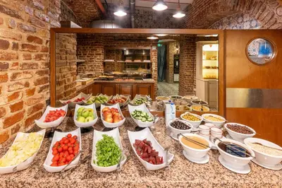 a counter topped with lots of bowls of food at Meserret Palace Hotel - Special Category in Istanbul