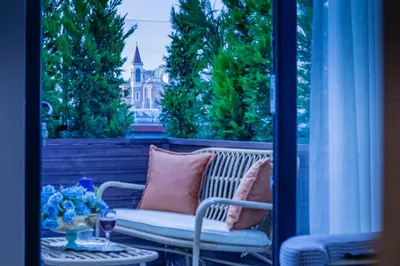 a porch with a bench and a table and a window at Lord Morgan & Exclusive Design Residence Cihangir in Istanbul