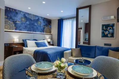 a hotel room with a bed and two tables and chairs at Lord Morgan & Exclusive Design Residence Cihangir in Istanbul
