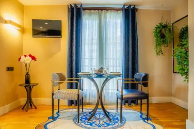 a dining room with a table and chairs in front of a window at Lord Morgan & Exclusive Design Residence Cihangir in Istanbul