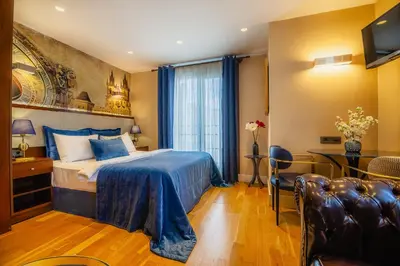 a hotel room with a bed and a table and chairs at Lord Morgan & Exclusive Design Residence Cihangir in Istanbul