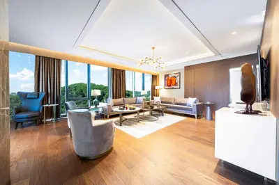 a living room with a couch and chairs and a tv at Radisson Collection Hotel, Vadistanbul in Istanbul