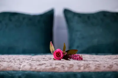 a pink rose sitting on top of a bed at ATAM HOTEL in Istanbul