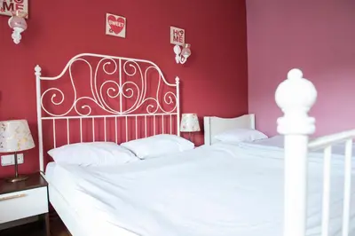 a bedroom with a white bed and red walls at Cheers Midtown Hostel in Istanbul