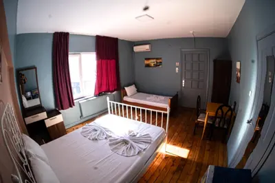 a small bedroom with a bed and a window at Cheers Midtown Hostel in Istanbul