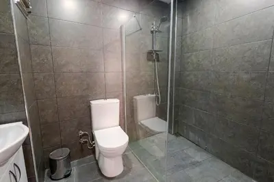 a bathroom with a toilet and a shower and a sink at Cheers Midtown Hostel in Istanbul