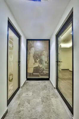 a hallway with two large framed paintings on the wall at Kavala Hotel in Bursa